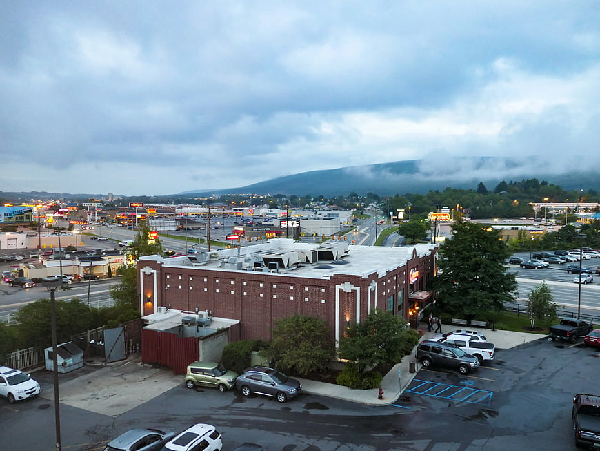 Overcast View of Brick Building and Highway with Mountains