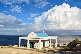 White Orthodox Church with Blue Dome by the Sea