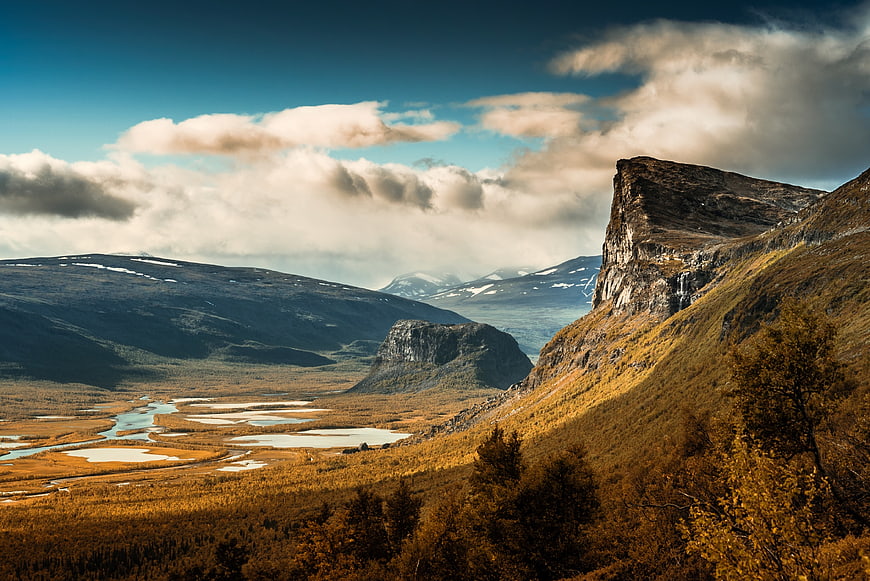 Scenic autumn mountain valley with river and clouds
