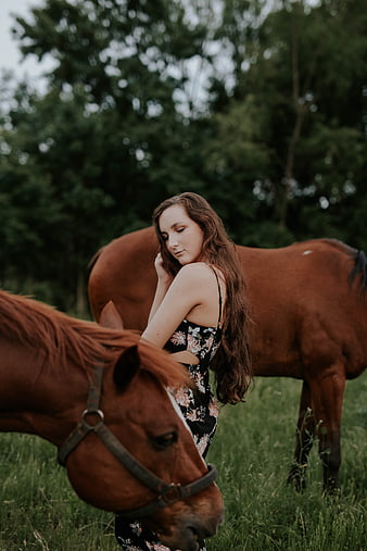 Young Woman with Horses in Green Pasture