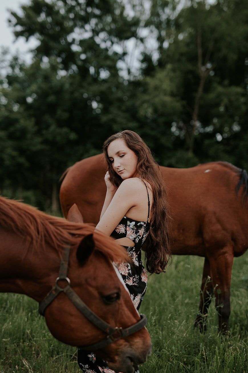 Young Woman with Horses in Green Pasture