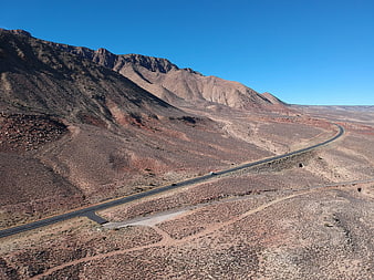 Aerial view of winding desert highway through mountains