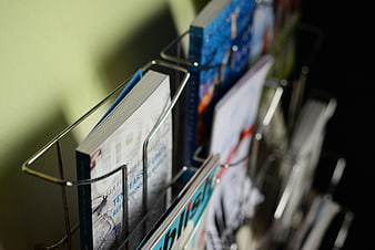 Close-up of magazines in a wire rack