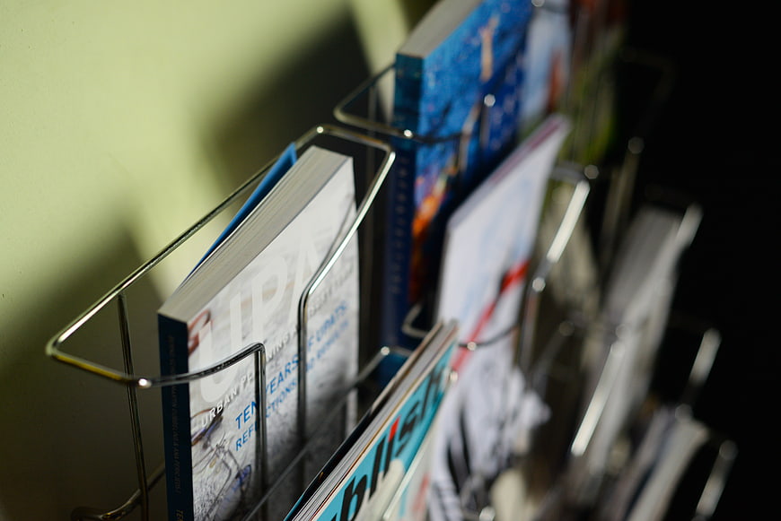 Close-up of magazines in a wire rack