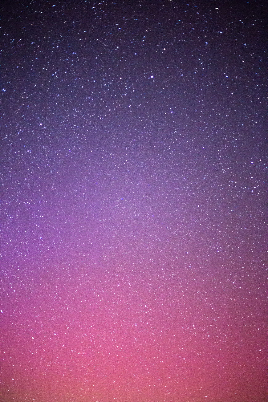 Starry Night Sky with Purple and Pink Gradient Background