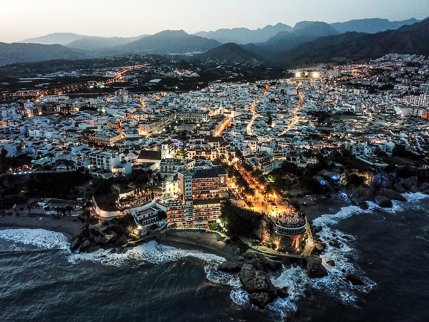 Aerial View of Nerja Spain at Dusk with Coastal Lights and Mountains
