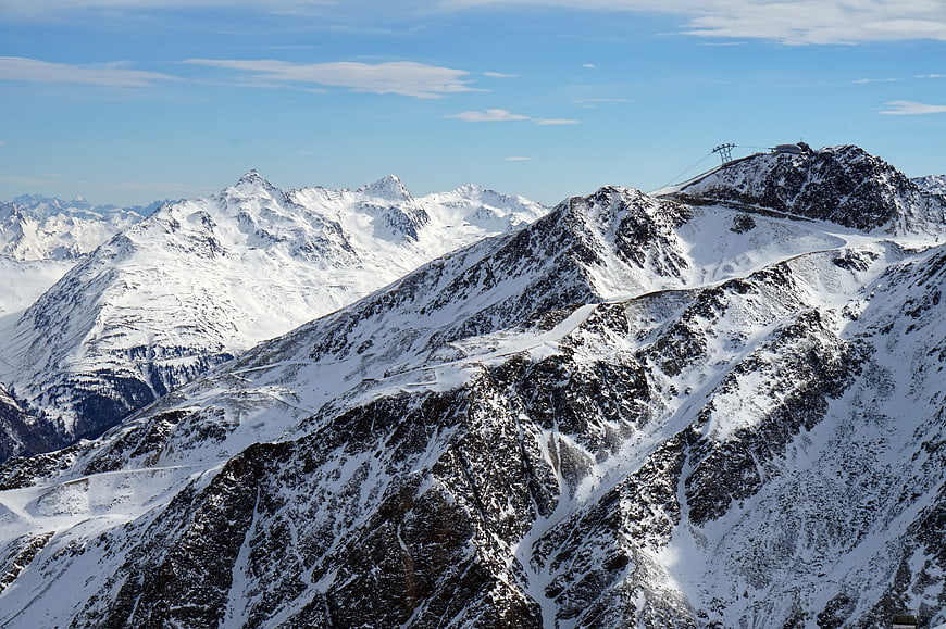 Snowy mountain peaks with ski lift in the Alps