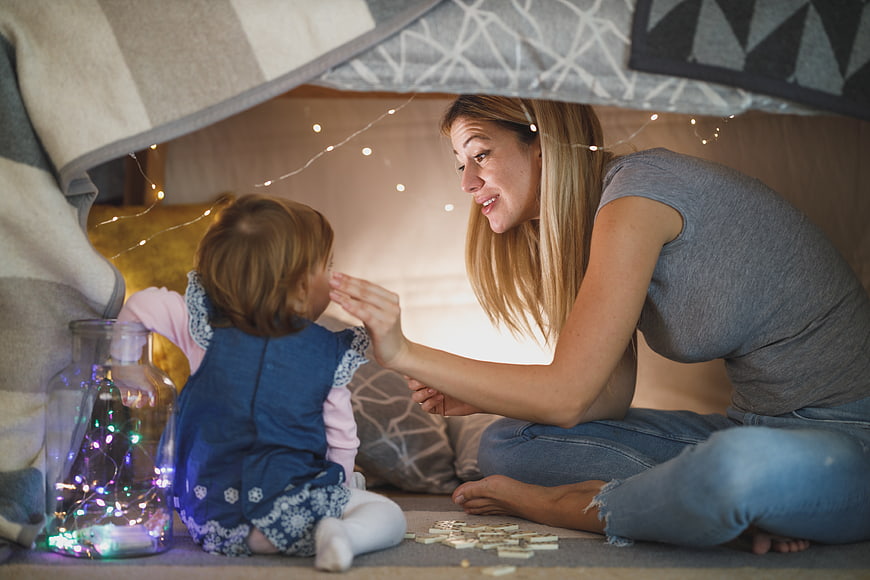 Mother and Toddler Playing in Cozy Blanket Fort