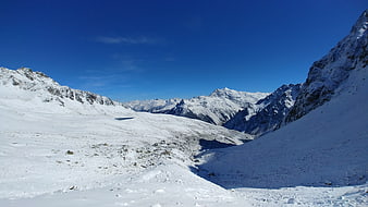 Snowy Mountain Valley Landscape with Blue Sky