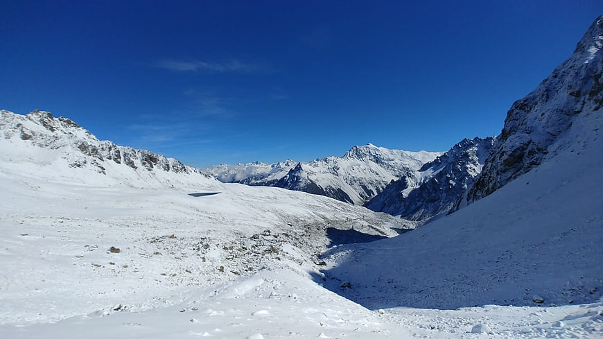 Snowy Mountain Valley Landscape with Blue Sky