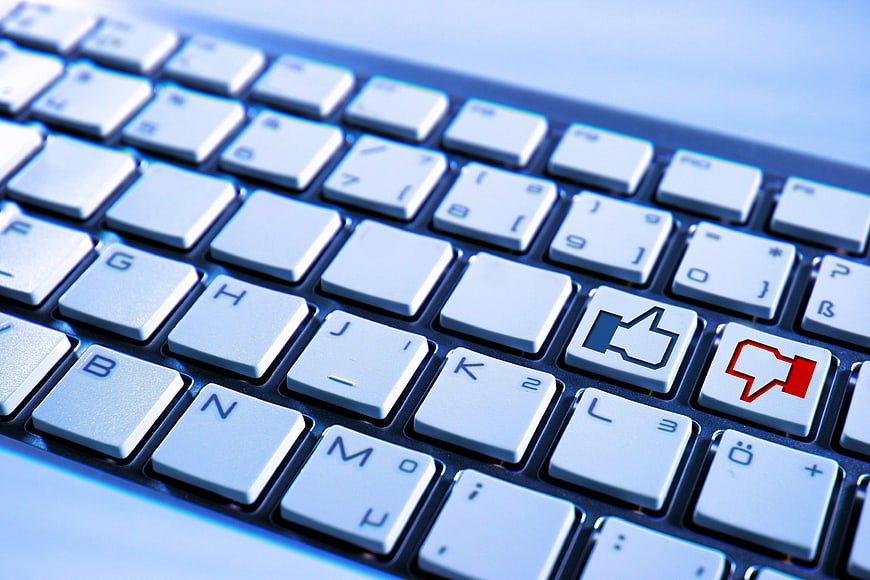 Close-up of computer keyboard with like and dislike buttons