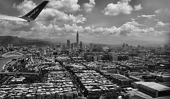 Aerial View of Taipei Cityscape with Airplane Wing