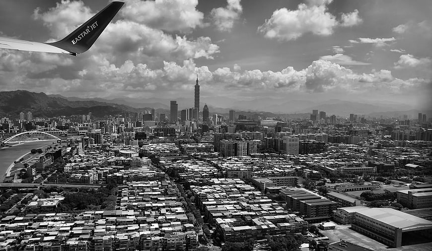Aerial View of Taipei Cityscape with Airplane Wing