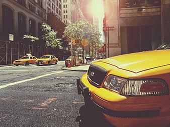 Yellow Taxi Cab on New York City Street with Sun Flare