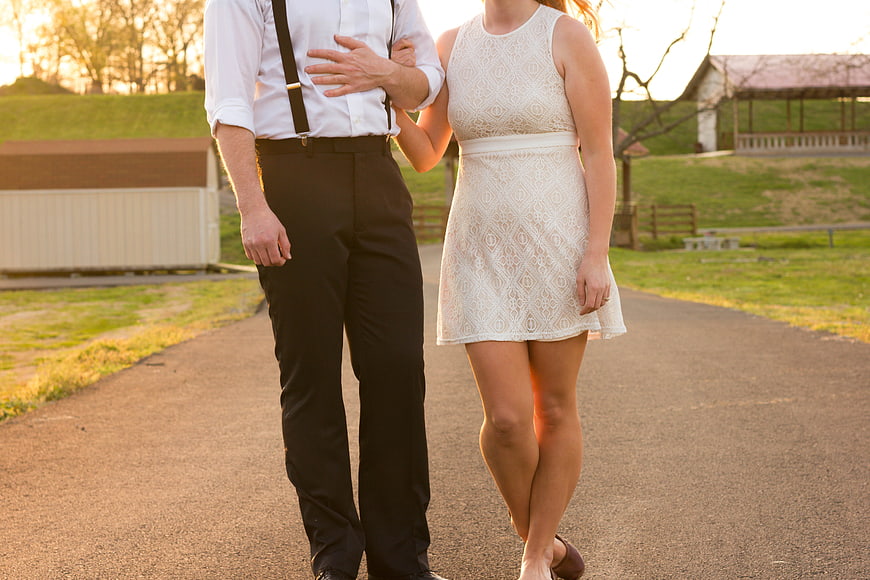 Couple Walking Arm in Arm on Paved Path at Sunset