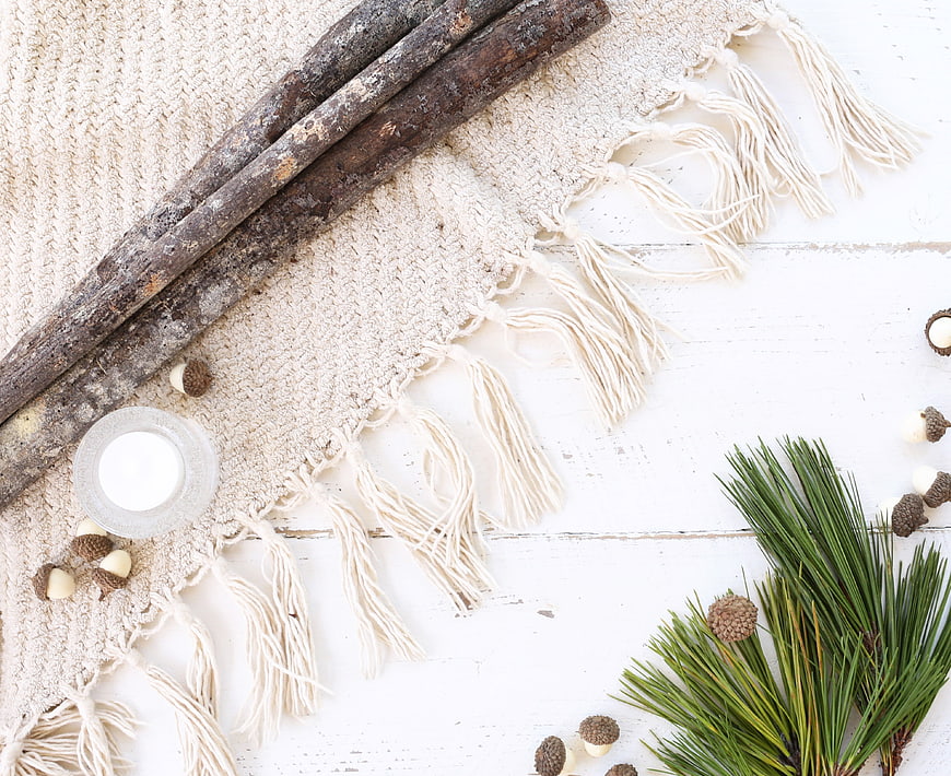 Rustic winter flat lay with pine branches and wooden sticks