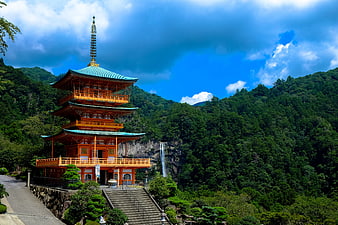 Japanese Pagoda Temple with Waterfall in Lush Mountains