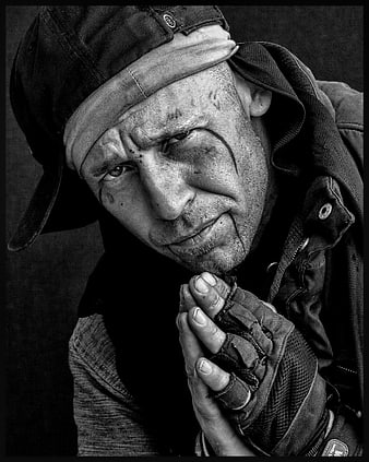 Black and white portrait of a distressed man with dirty face