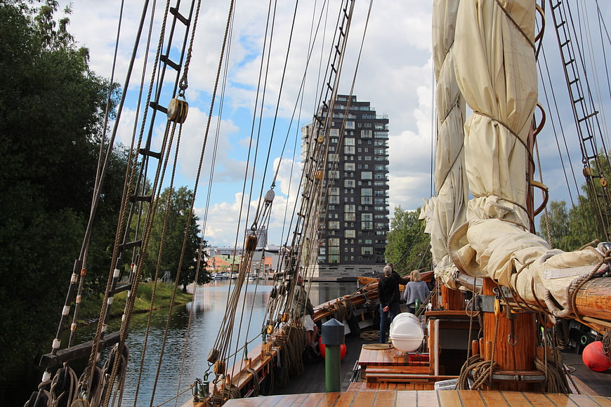 Deck of a historic sailing ship with modern city skyline