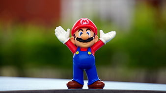 Super Mario Figurine with Arms Raised Outdoors