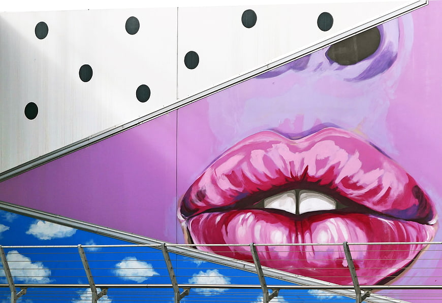 Vibrant Pink Lips Street Art Mural on Urban Building