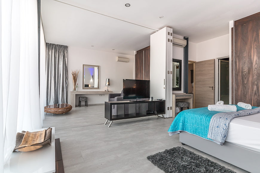 Modern luxury hotel suite interior with bedroom and living area
