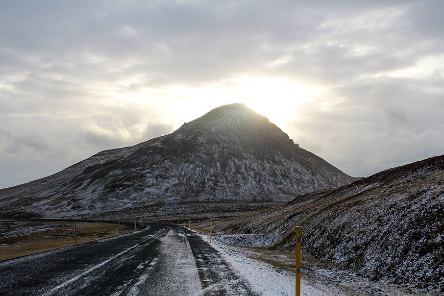 Snowy Mountain Road at Sunset with Golden Sunlight