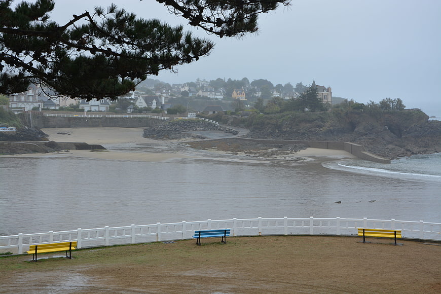 Coastal landscape with colorful benches and overcast sea view
