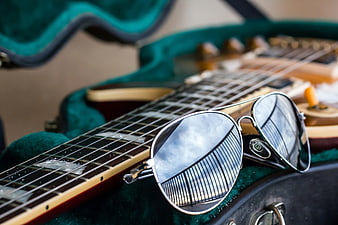 Aviator Sunglasses on Electric Guitar in Green Case