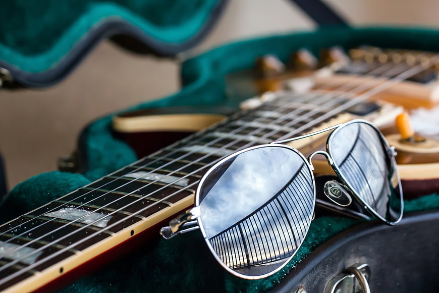 Aviator Sunglasses on Electric Guitar in Green Case