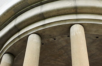Low angle view of weathered concrete architectural columns and arches