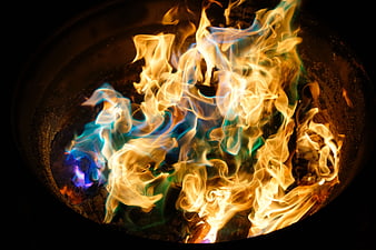 Colorful Flames Burning in a Fire Pit at Night