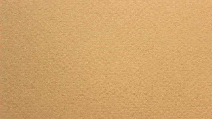 Close-up of textured beige paper background