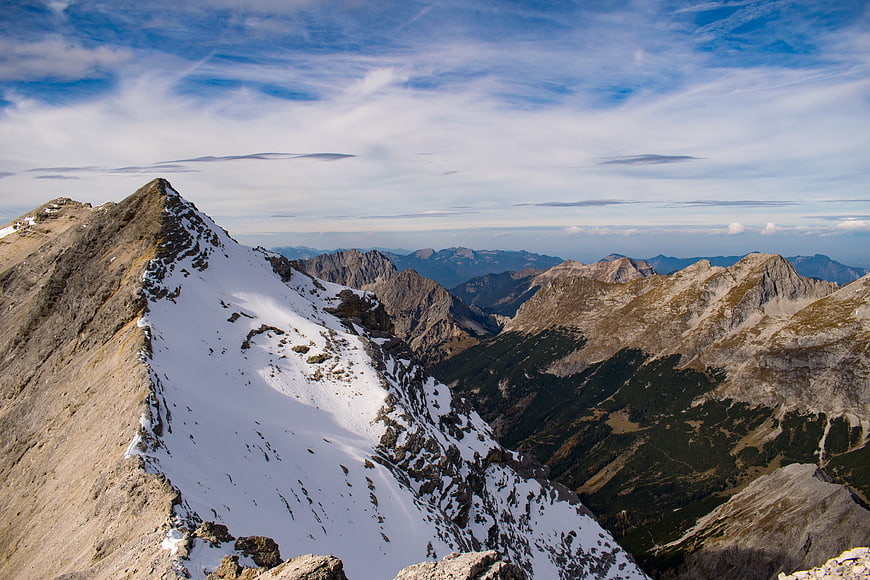 Snowy Alpine Mountain Peak with Blue Sky and Clouds