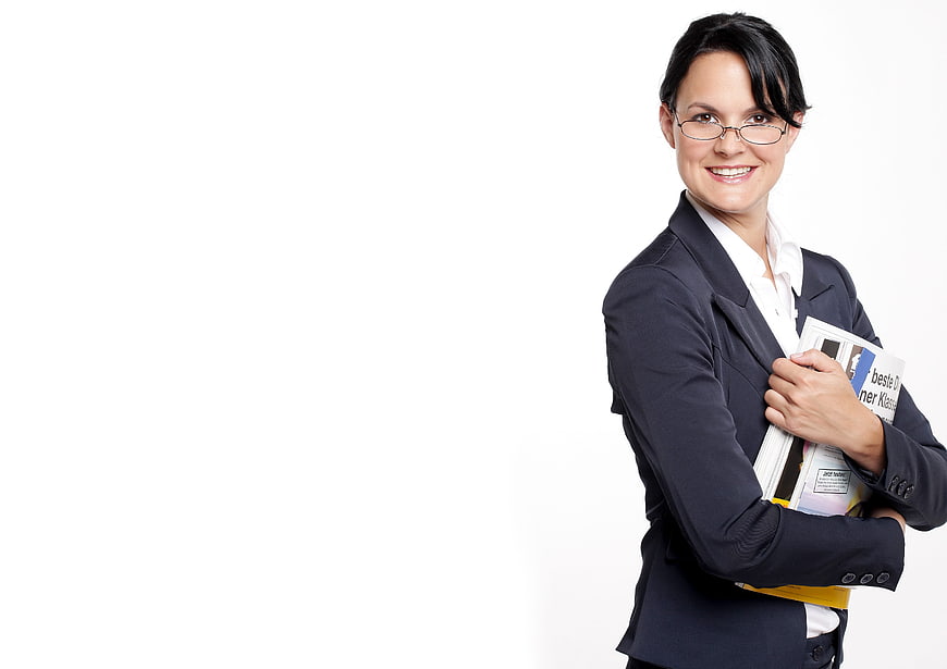 Smiling businesswoman holding documents against white background