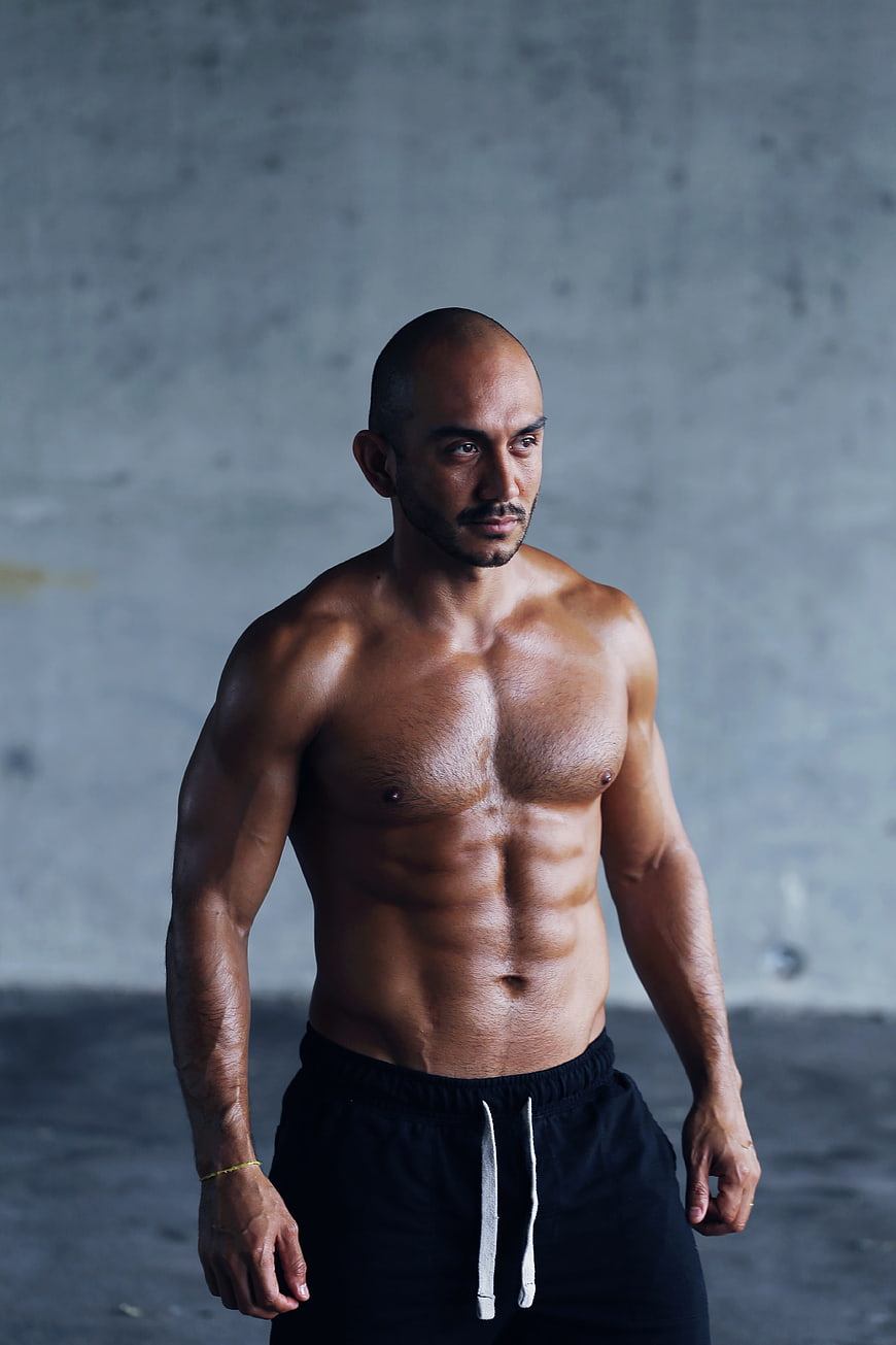 Muscular Shirtless Man with Defined Abs in Gym