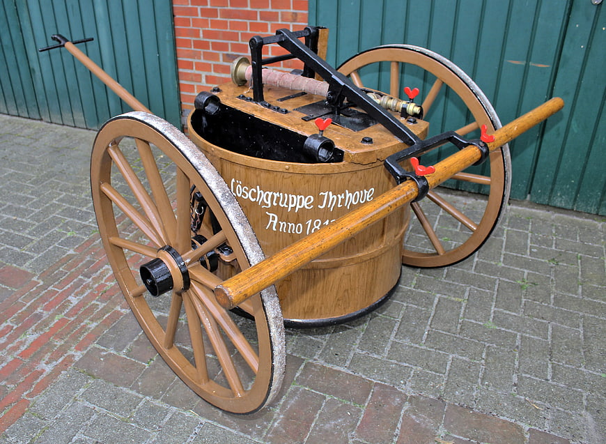 Vintage wooden horse-drawn fire engine cart with large wheels