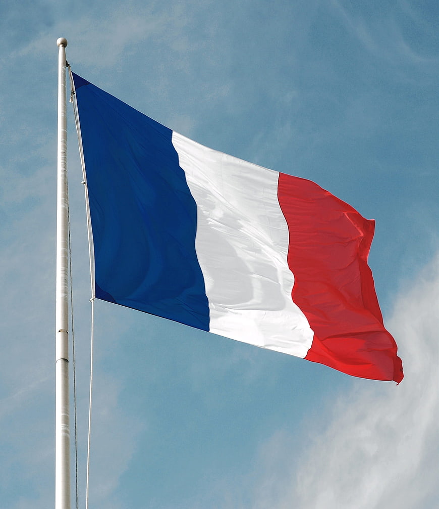 French National Flag Waving Against Blue Sky