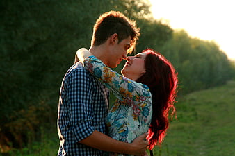 Romantic couple embracing in nature during golden hour