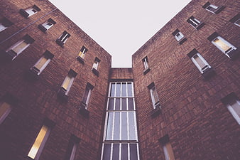 Low angle view of modern brick apartment building facade