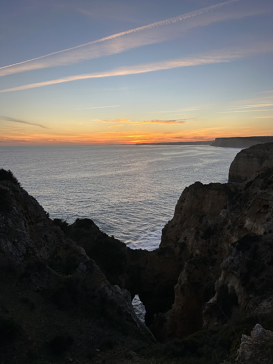 Sunset over Rugged Coastal Cliffs and Ocean Horizon