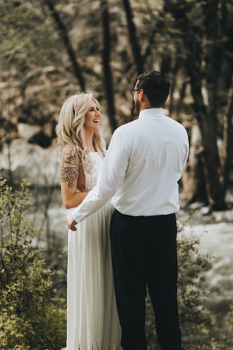 Happy Bride and Groom Laughing in Forest
