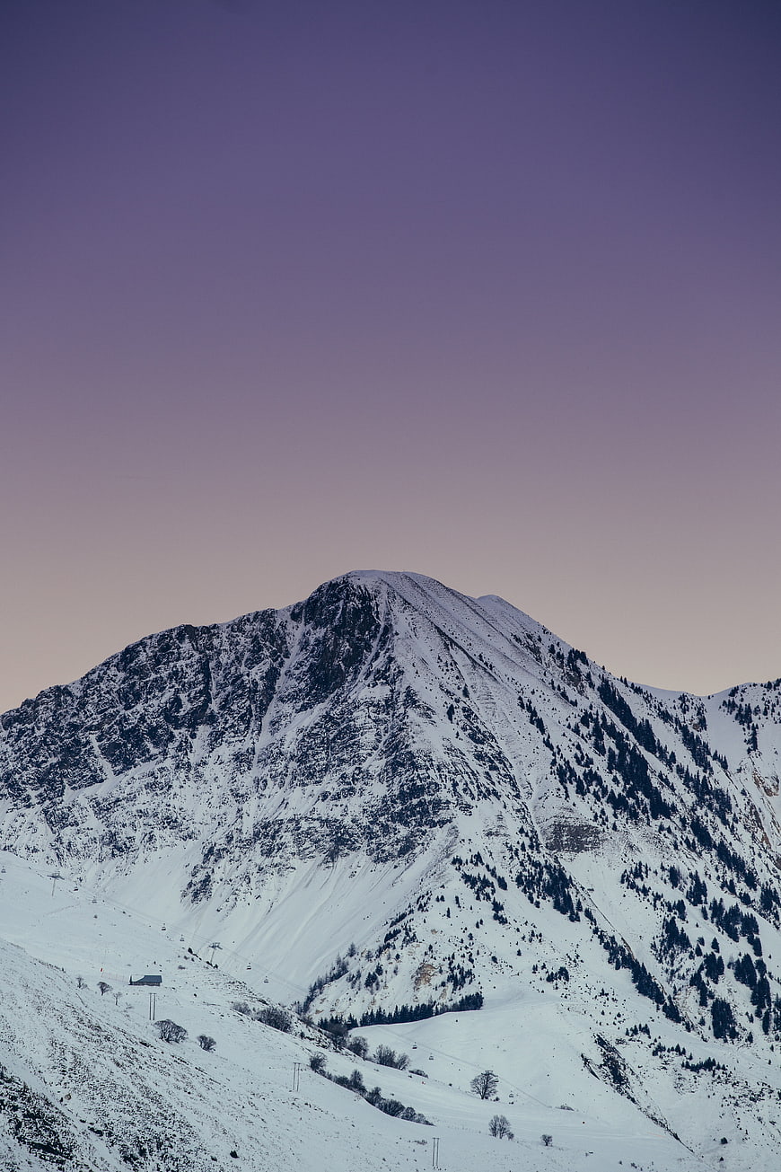Snowy Mountain Peak at Dusk with Purple Sky