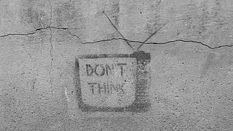 Don't Think Graffiti on Cracked Concrete Wall