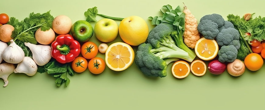 Fresh Assorted Fruits and Vegetables Flat Lay on Green Background