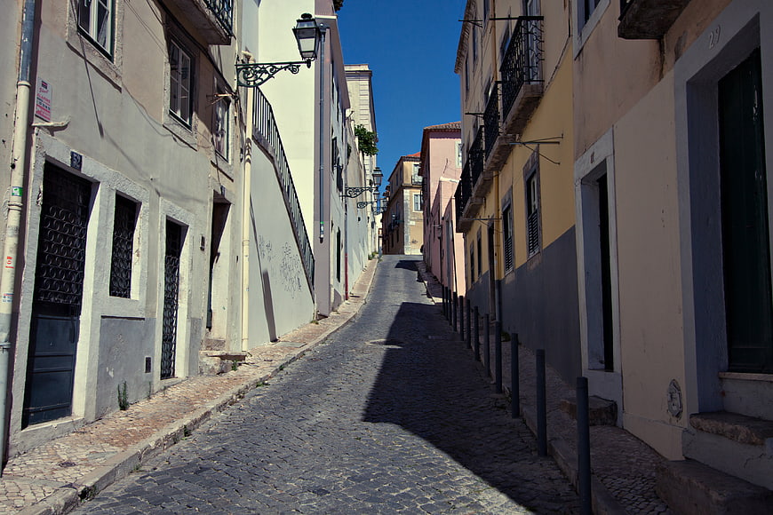 Narrow cobblestone street in Lisbon, Portugal
