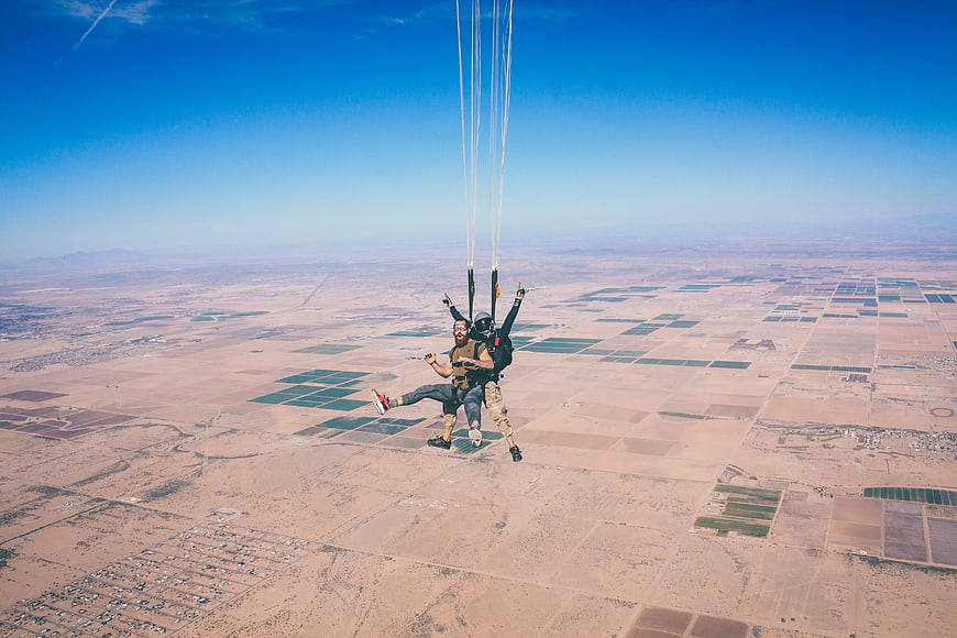 Skydiving tandem jump over desert agricultural fields