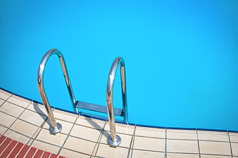 Chromium Pool Ladder Against Vibrant Blue Water
