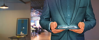 Businessman holding tablet with holographic interface in office