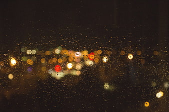 Abstract Night City Bokeh Through Rainy Window Glass